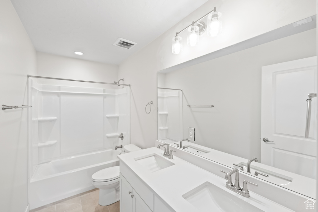 Bathroom with shower / bath combination, double vanity, toilet, and recessed lighting