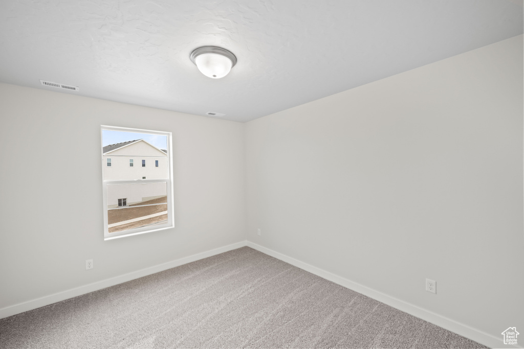 Empty room with baseboards and carpet flooring