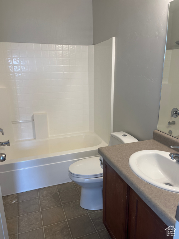 Full bath featuring vanity, toilet, tub / shower combination, and tile patterned floors