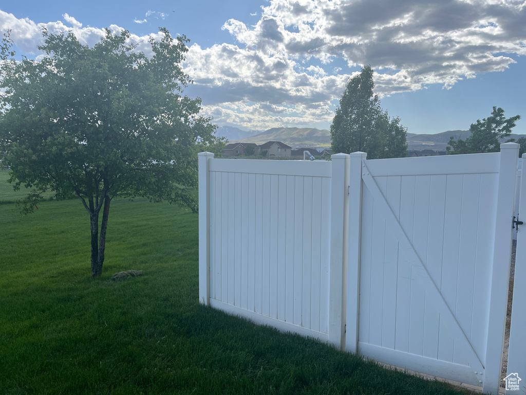 View of yard featuring a gate and a mountain view