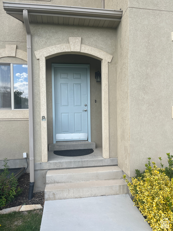 Entrance to property featuring stucco siding