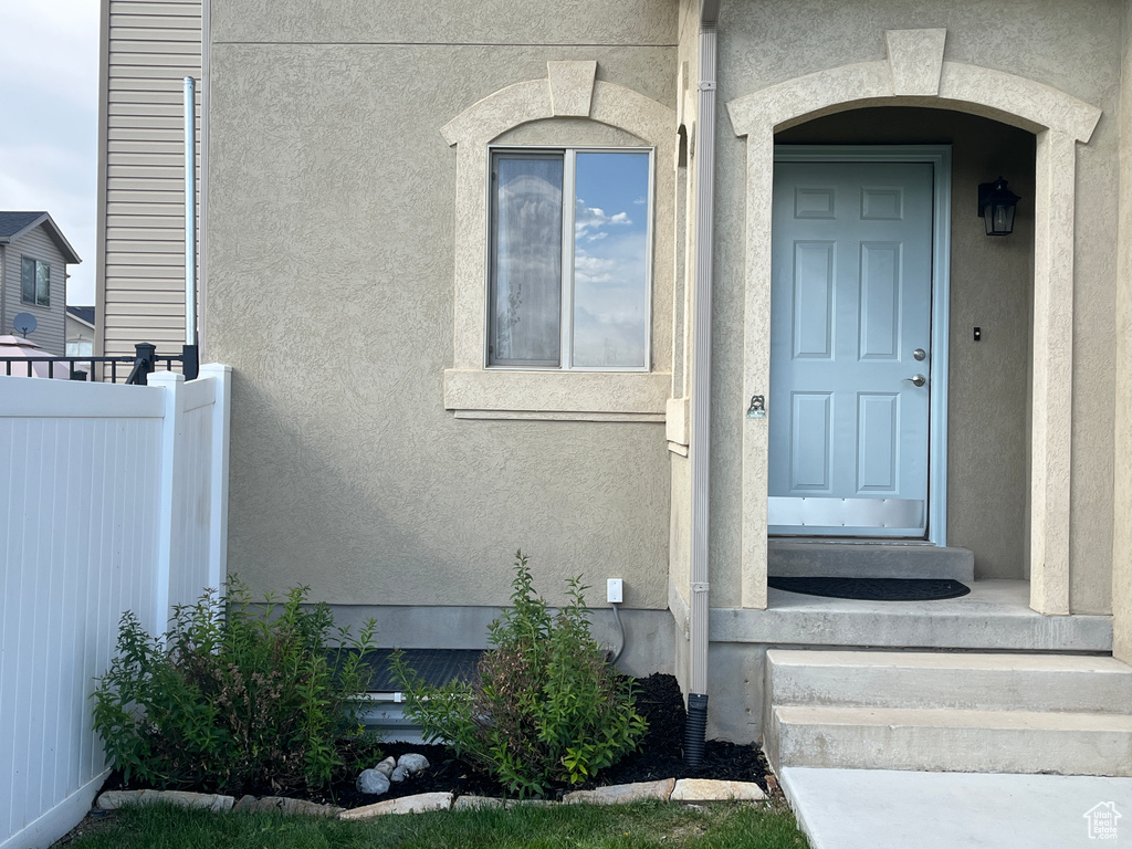 Entrance to property featuring stucco siding