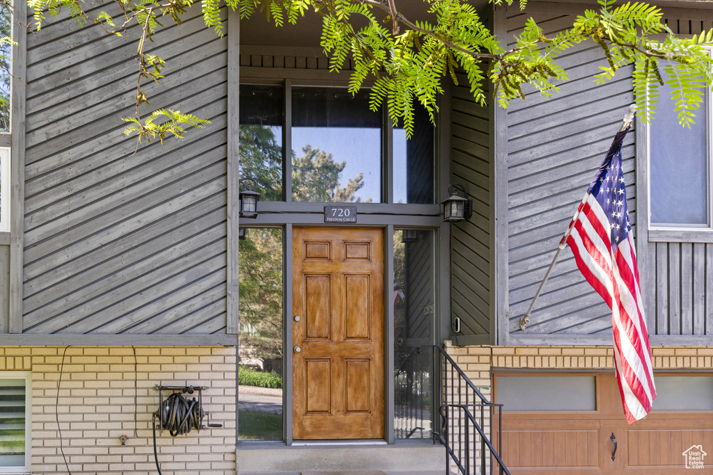 View of exterior entry with brick siding