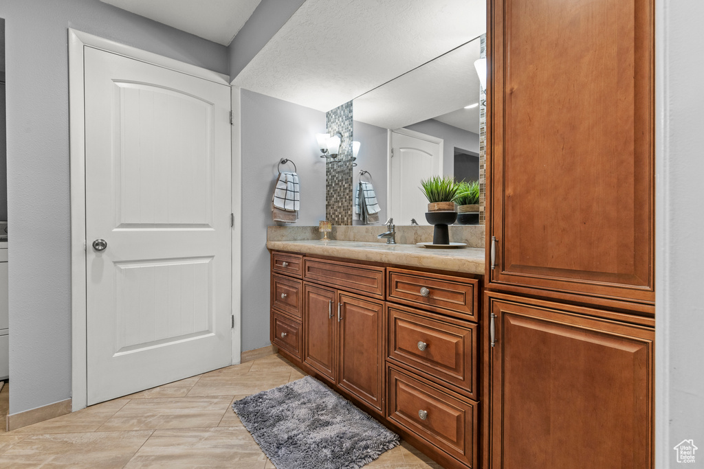 Bathroom featuring vanity and a chandelier