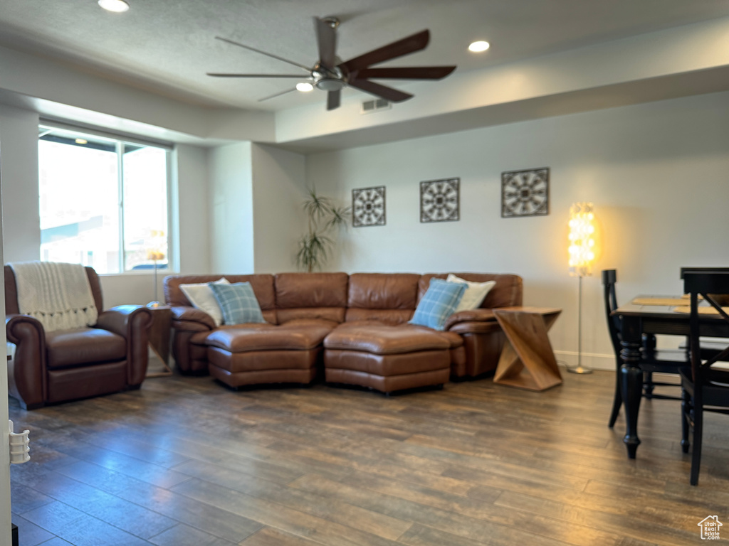 Living area featuring dark wood finished floors, ceiling fan, recessed lighting, and baseboards