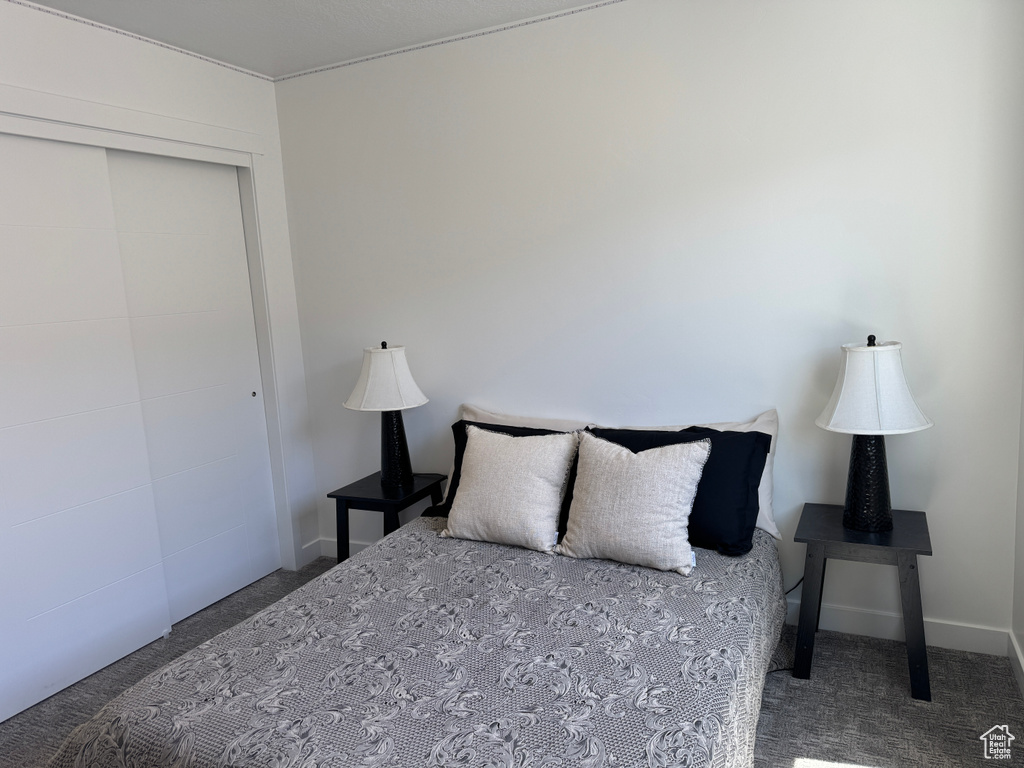 Carpeted bedroom with a closet
