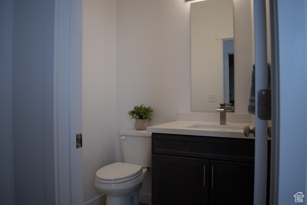 Half bathroom with vanity and toilet