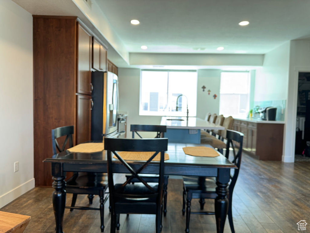 Dining space featuring dark wood finished floors, recessed lighting, and baseboards