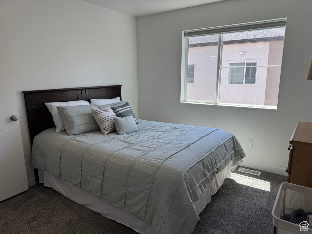 Bedroom featuring carpet flooring and baseboards