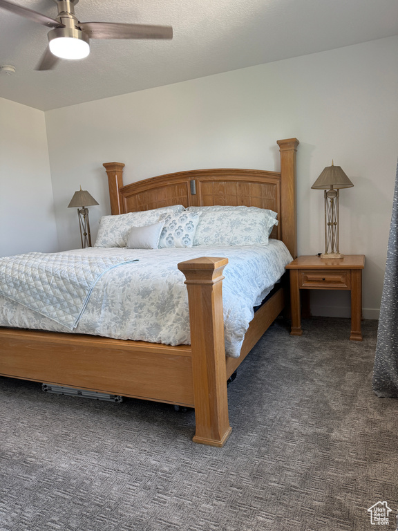Carpeted bedroom featuring ceiling fan