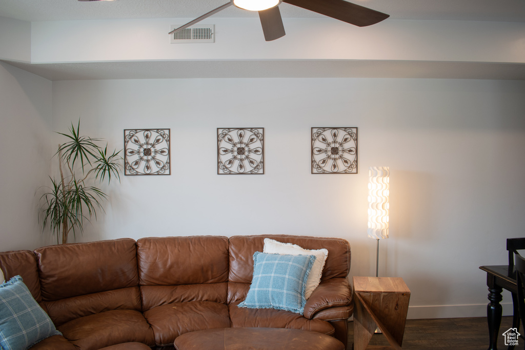 Living area featuring dark wood finished floors and ceiling fan