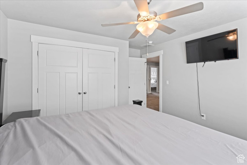 Bedroom with ceiling fan and a closet