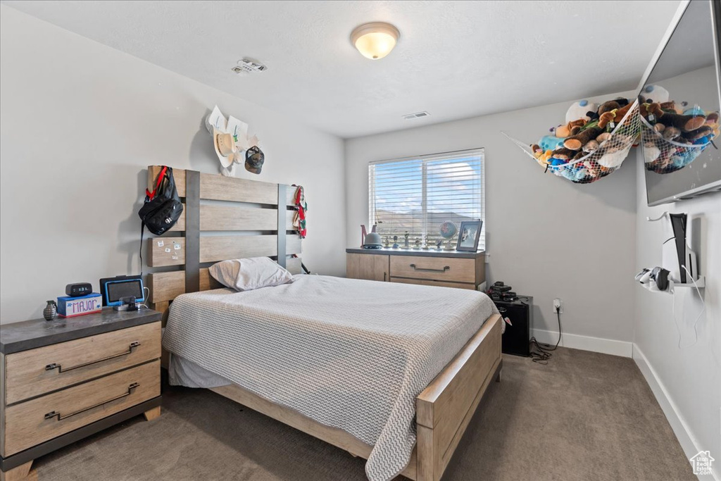 Carpeted bedroom featuring baseboards