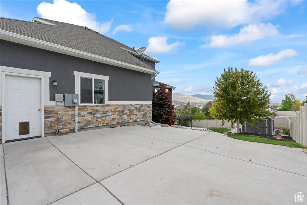 Fenced backyard with a patio area and a mountain view