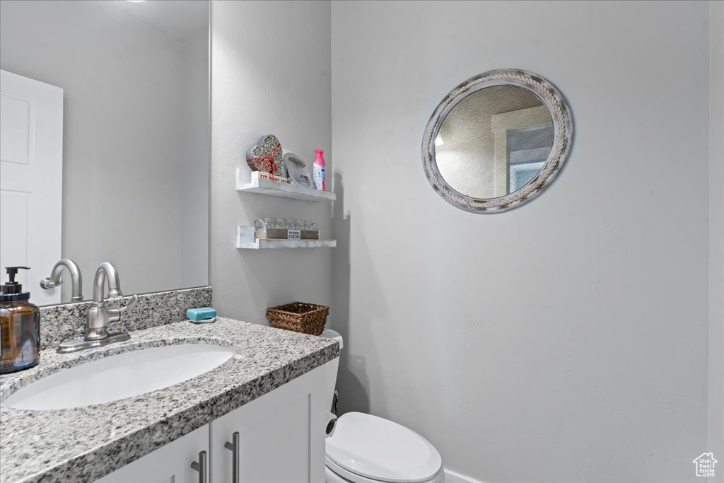 Half bathroom with toilet and vanity