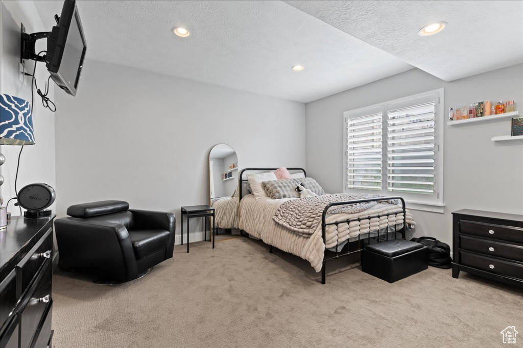 Bedroom featuring light colored carpet, recessed lighting, and a textured ceiling