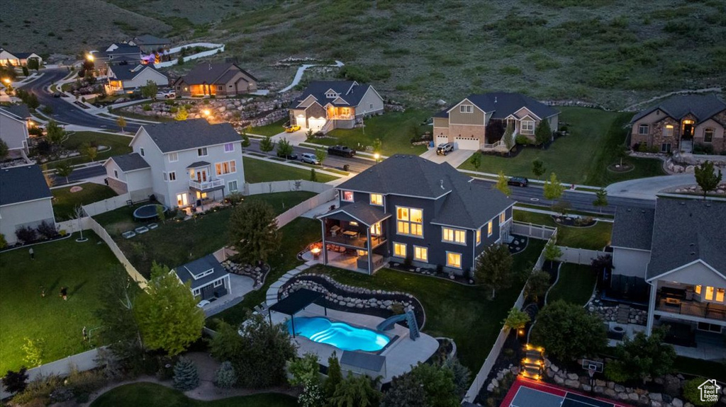 View of property location with a pool and nearby suburban area