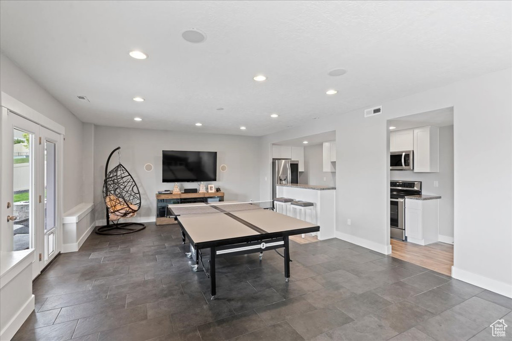 Recreation room with recessed lighting and baseboards