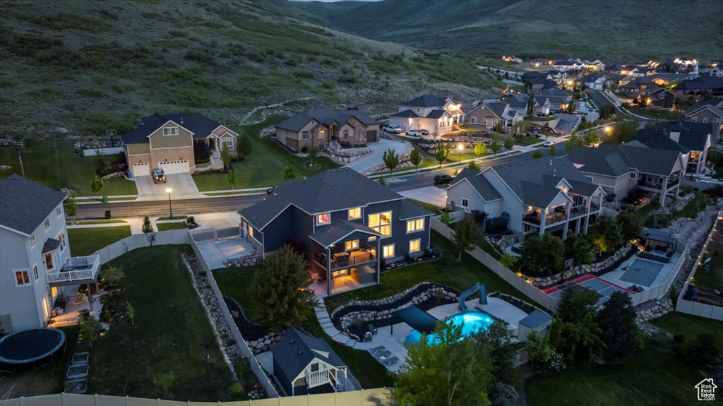 Aerial overview of property's location featuring nearby suburban area and a mountain backdrop