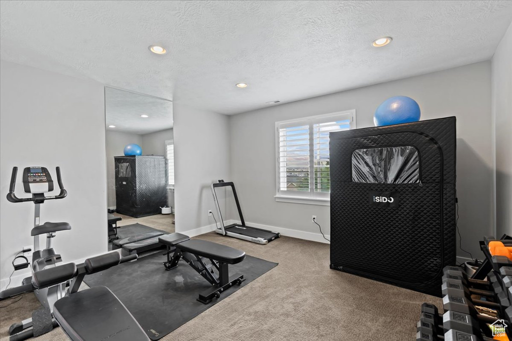 Exercise area featuring carpet floors, recessed lighting, baseboards, and a textured ceiling