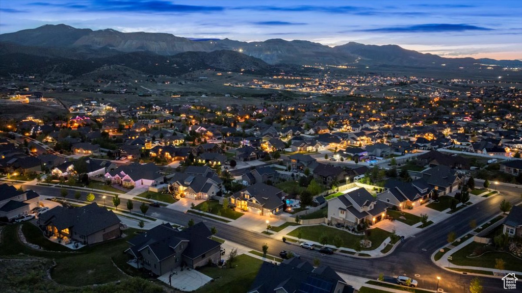 Aerial view of property's location featuring mountains and nearby suburban area