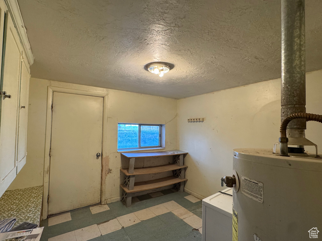 Utility room featuring gas water heater