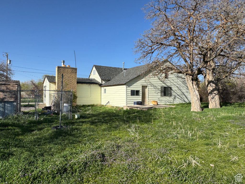 Back of house with a shingled roof