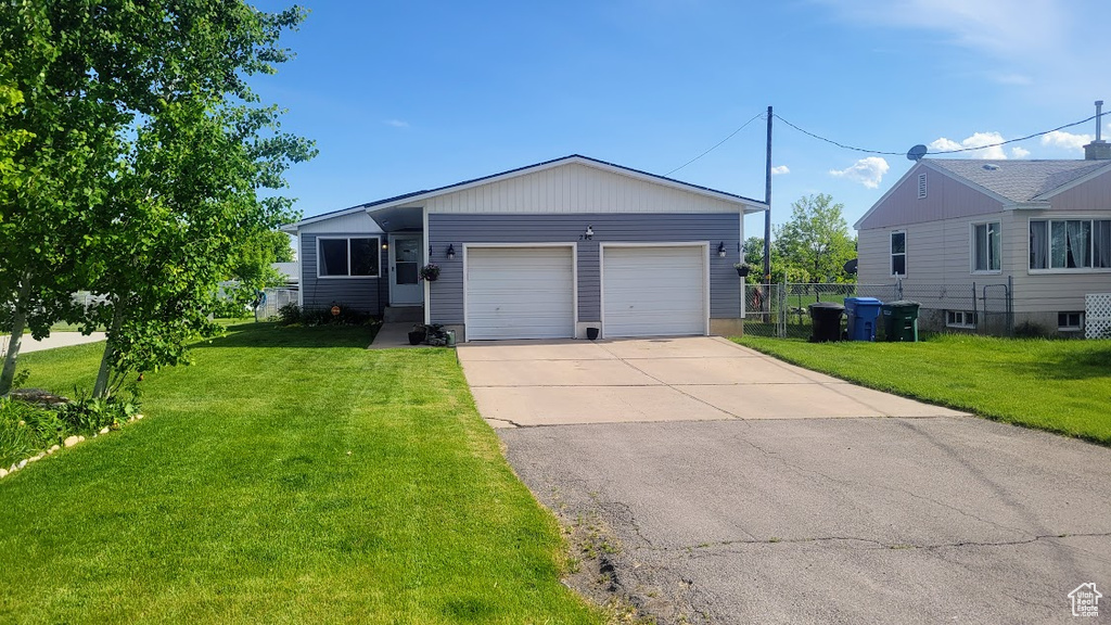 Single story home featuring an attached garage and driveway