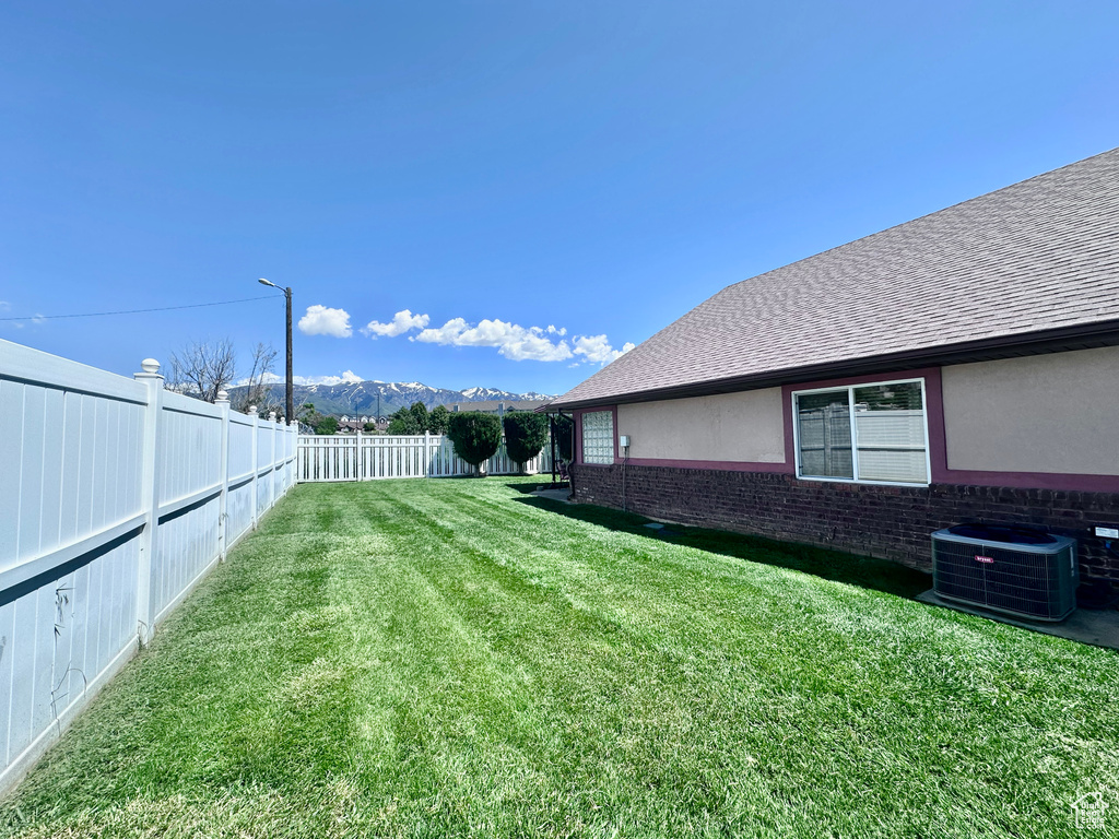 View of yard with a mountain view and cooling unit