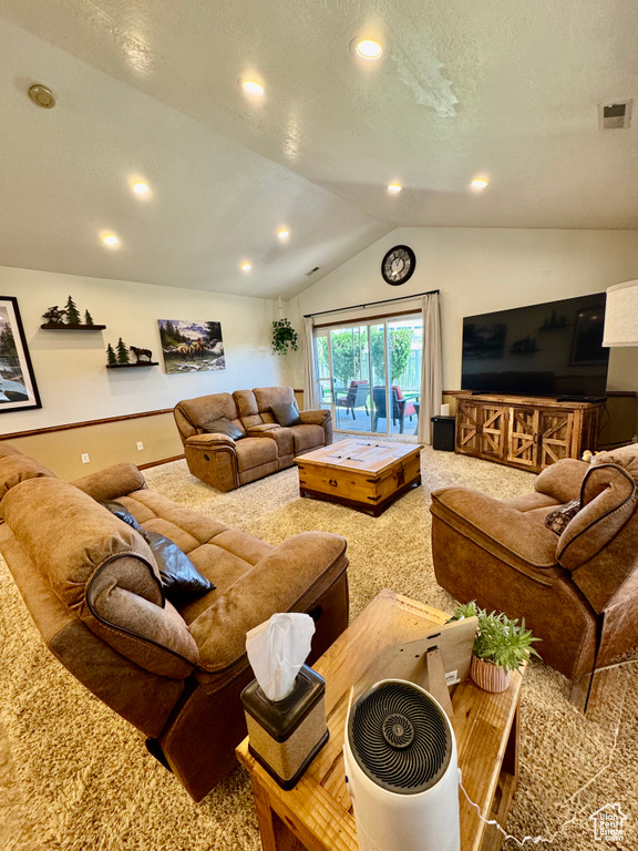 Living area with carpet flooring, lofted ceiling, recessed lighting, and baseboards
