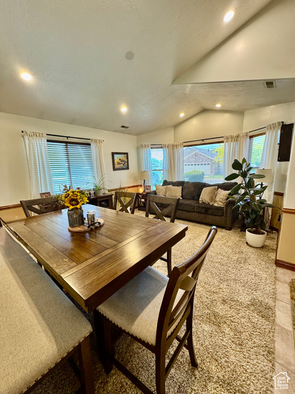 Dining space with recessed lighting and lofted ceiling