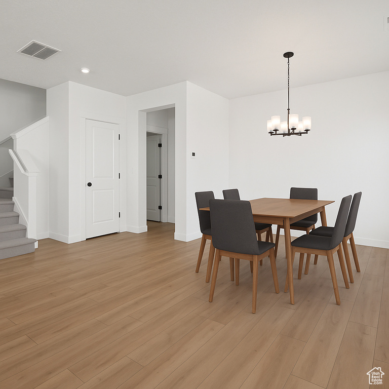 Dining room with a chandelier, stairway, light wood-style flooring, baseboards, and recessed lighting