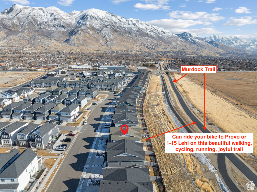 Aerial overview of property\\\'s location featuring a mountain backdrop and nearby suburban area