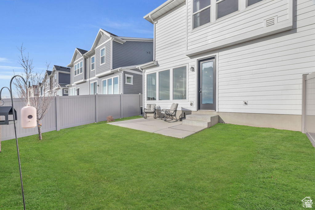 Back of house featuring entry steps, a patio area, and a residential view