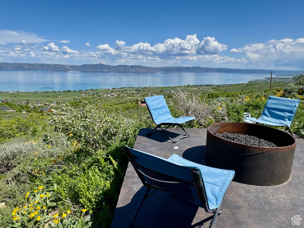 View of patio / terrace featuring a water and mountain view