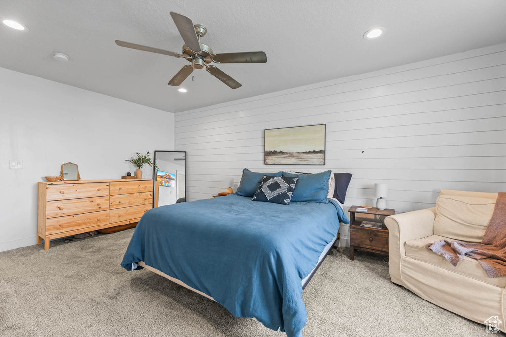 Bedroom with carpet, recessed lighting, ceiling fan, and wood walls