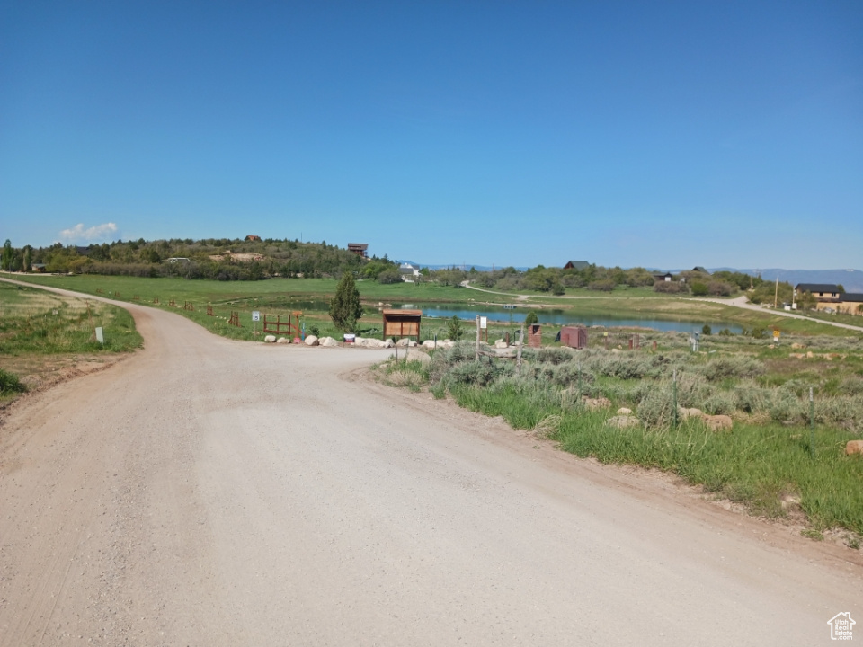 View of dirt / gravel road featuring a water view