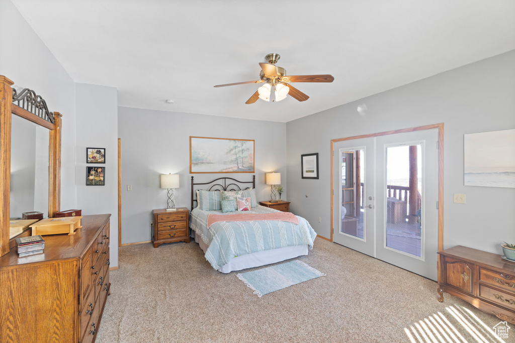 Bedroom featuring access to outside, french doors, light colored carpet, and ceiling fan