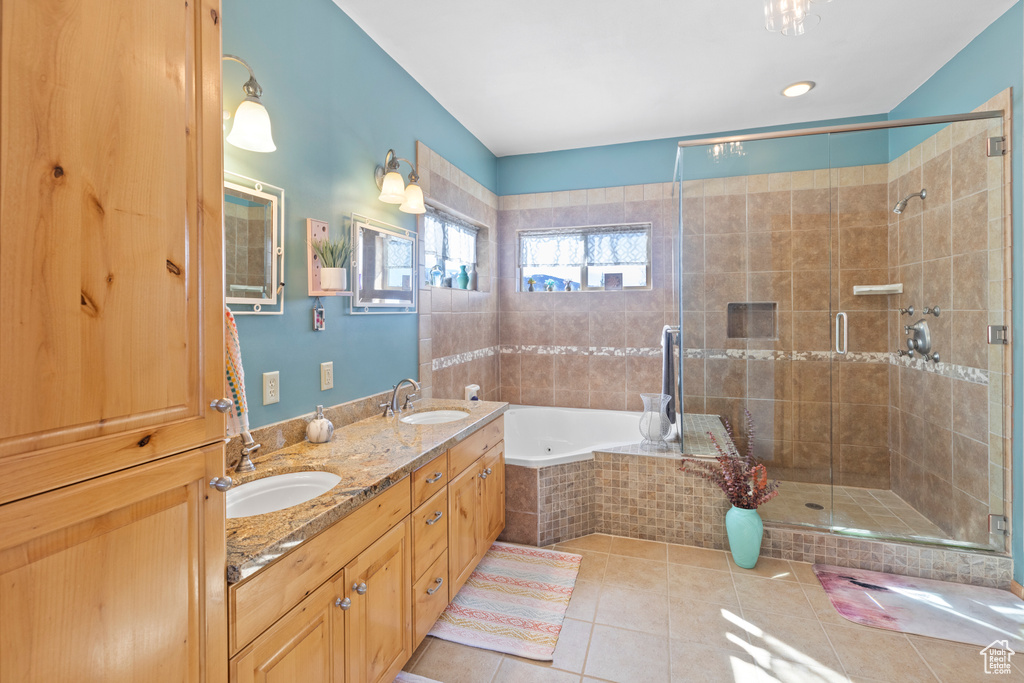 Bathroom with a bath, tile patterned floors, double vanity, and a stall shower