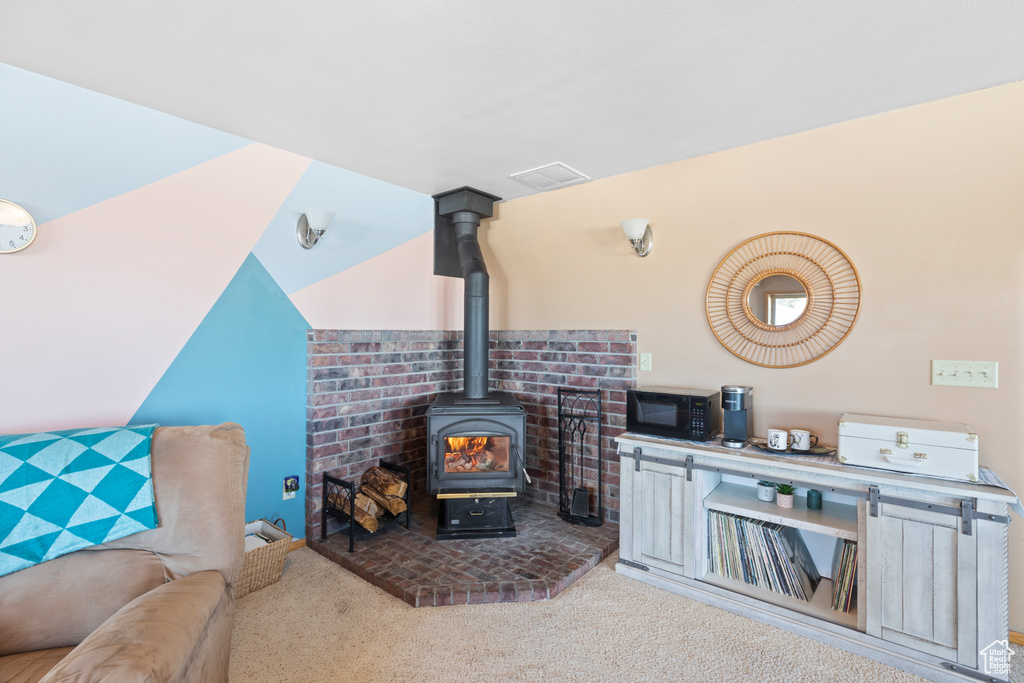 Living room featuring a wood stove and carpet floors