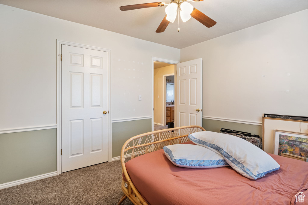 Bedroom with carpet flooring, a ceiling fan, and baseboards