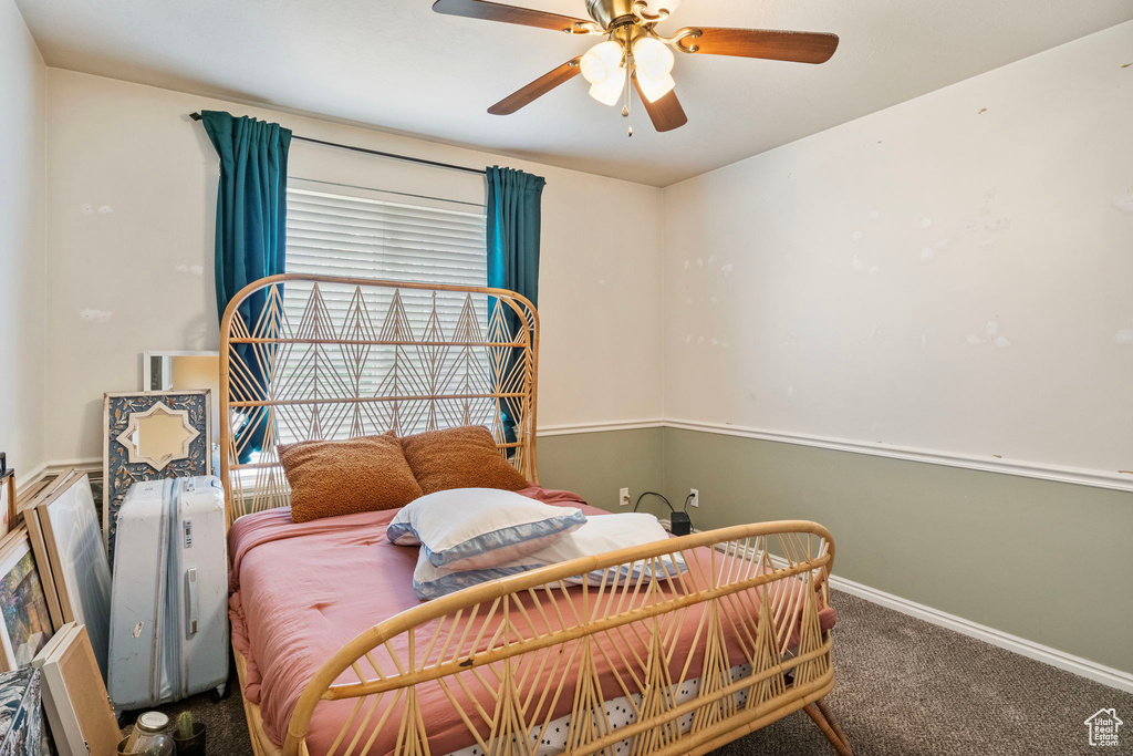Bedroom with carpet floors, baseboards, and ceiling fan