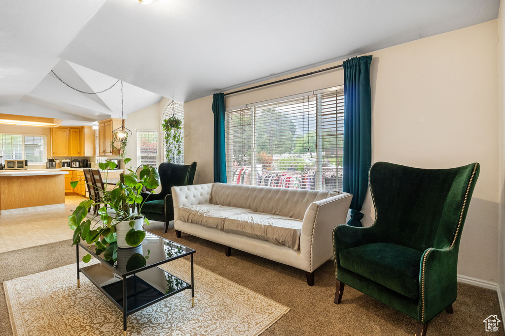 Living room with vaulted ceiling and light carpet