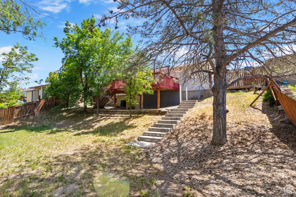View of yard with stairway and a wooden deck