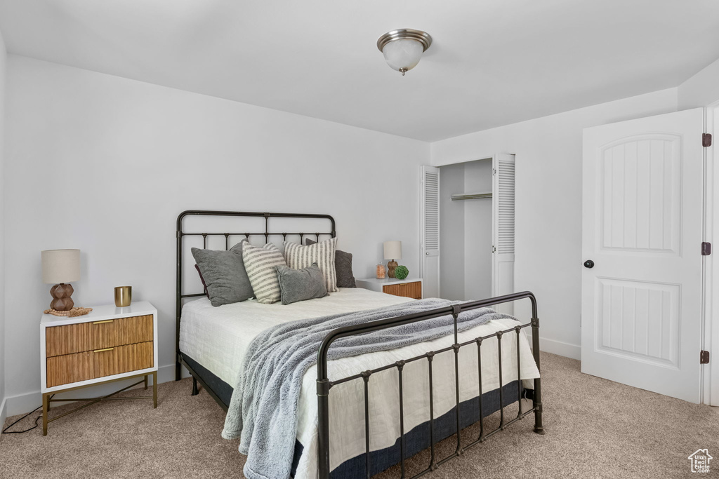 Carpeted bedroom featuring baseboards