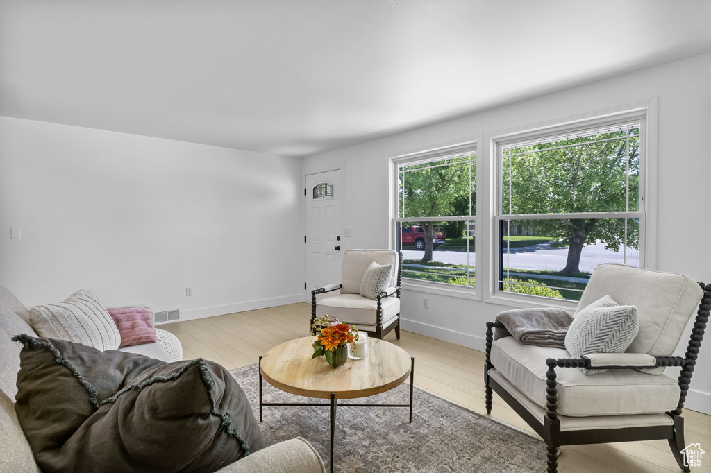 Living room featuring light wood-style floors and baseboards
