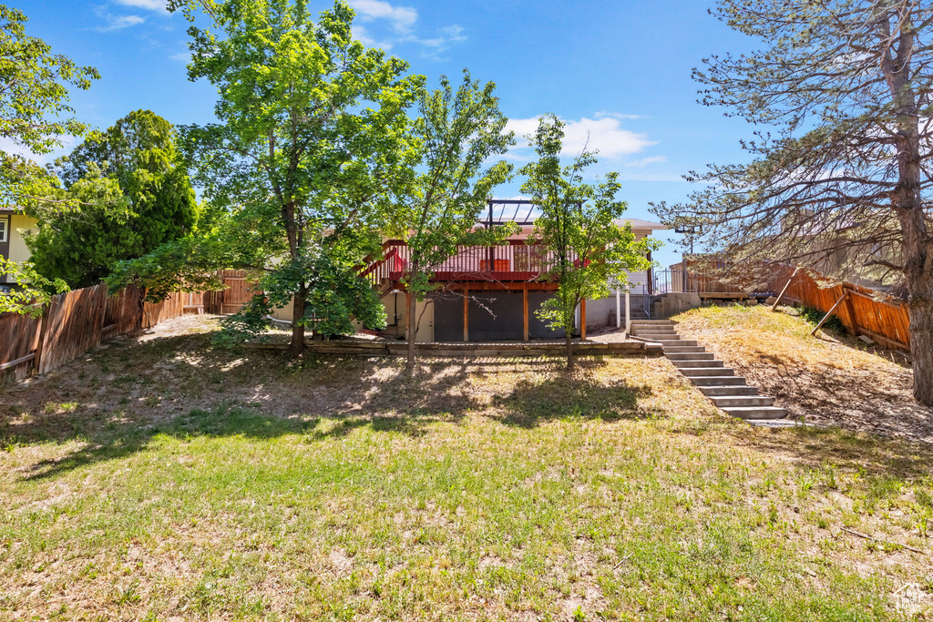 View of yard featuring stairs and a deck