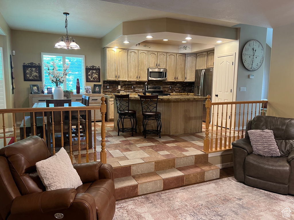 Living area featuring recessed lighting, a chandelier, and baseboards