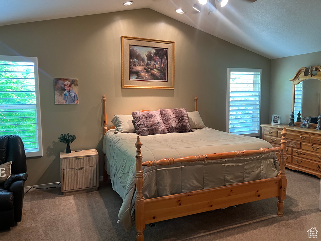 Carpeted bedroom with vaulted ceiling and recessed lighting