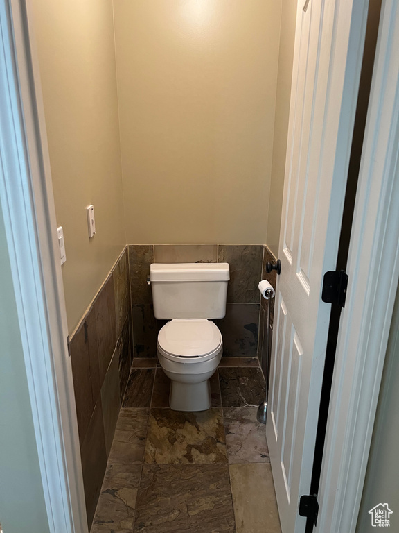 Bathroom featuring wainscoting and toilet